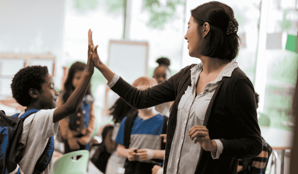 teacher high fiving student