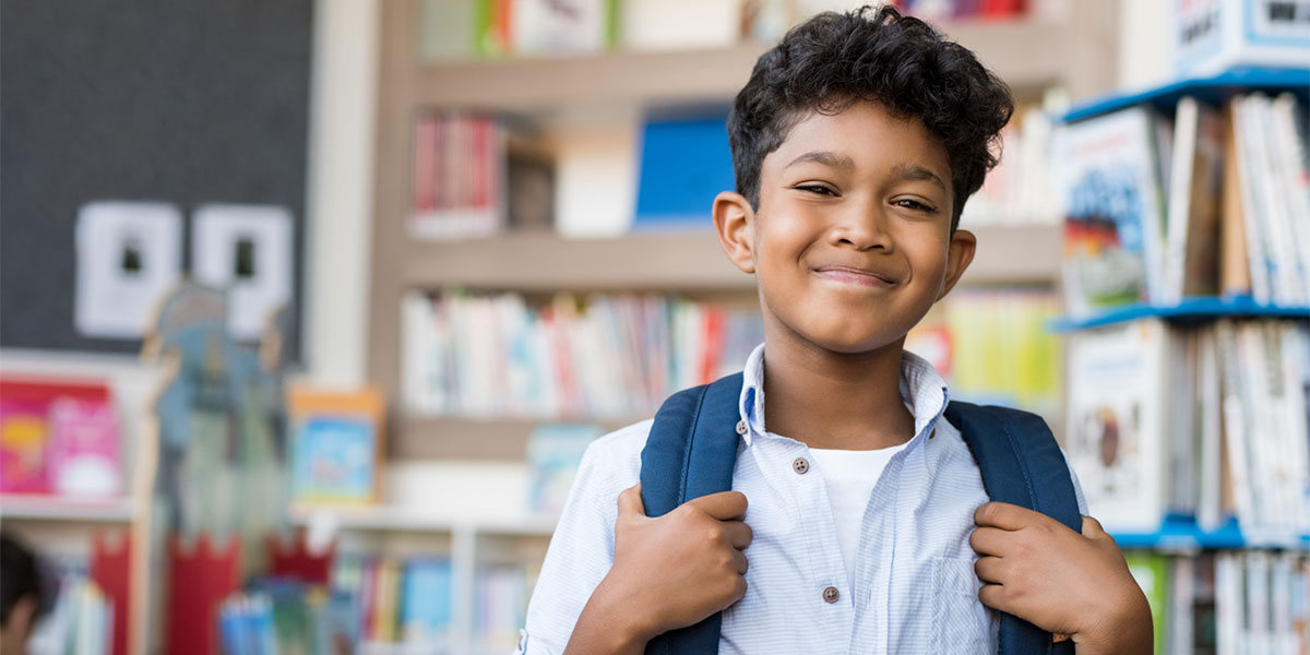 young student smiling with backpack